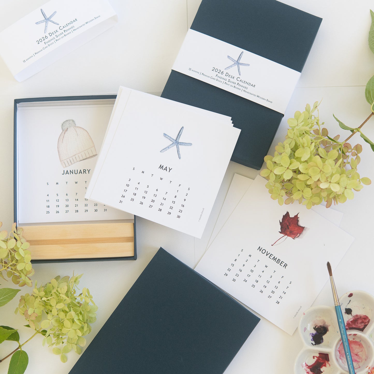 Calendar boxed set with starfish design on a white surface with flowers