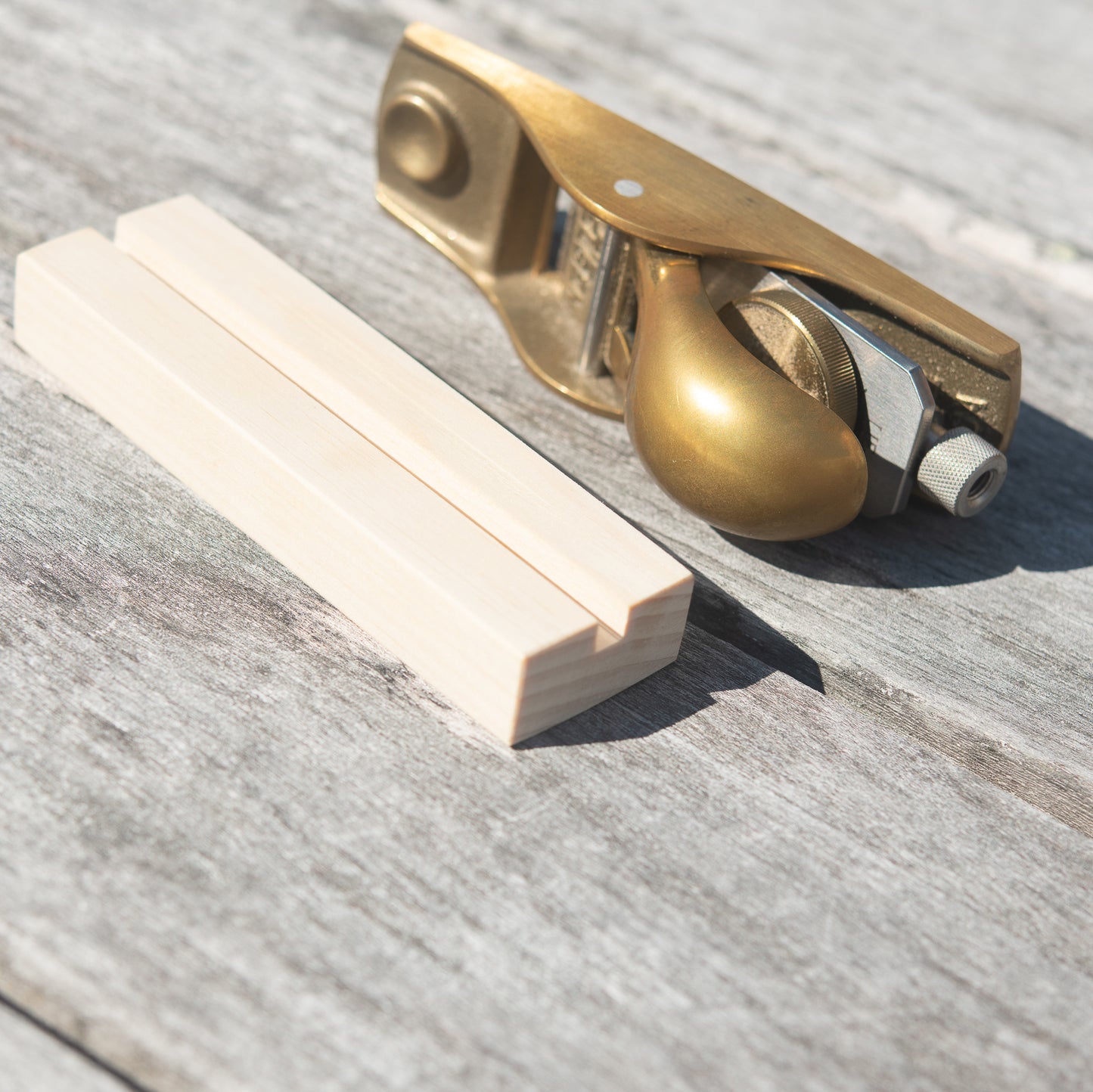 Brass plane with wooden stand