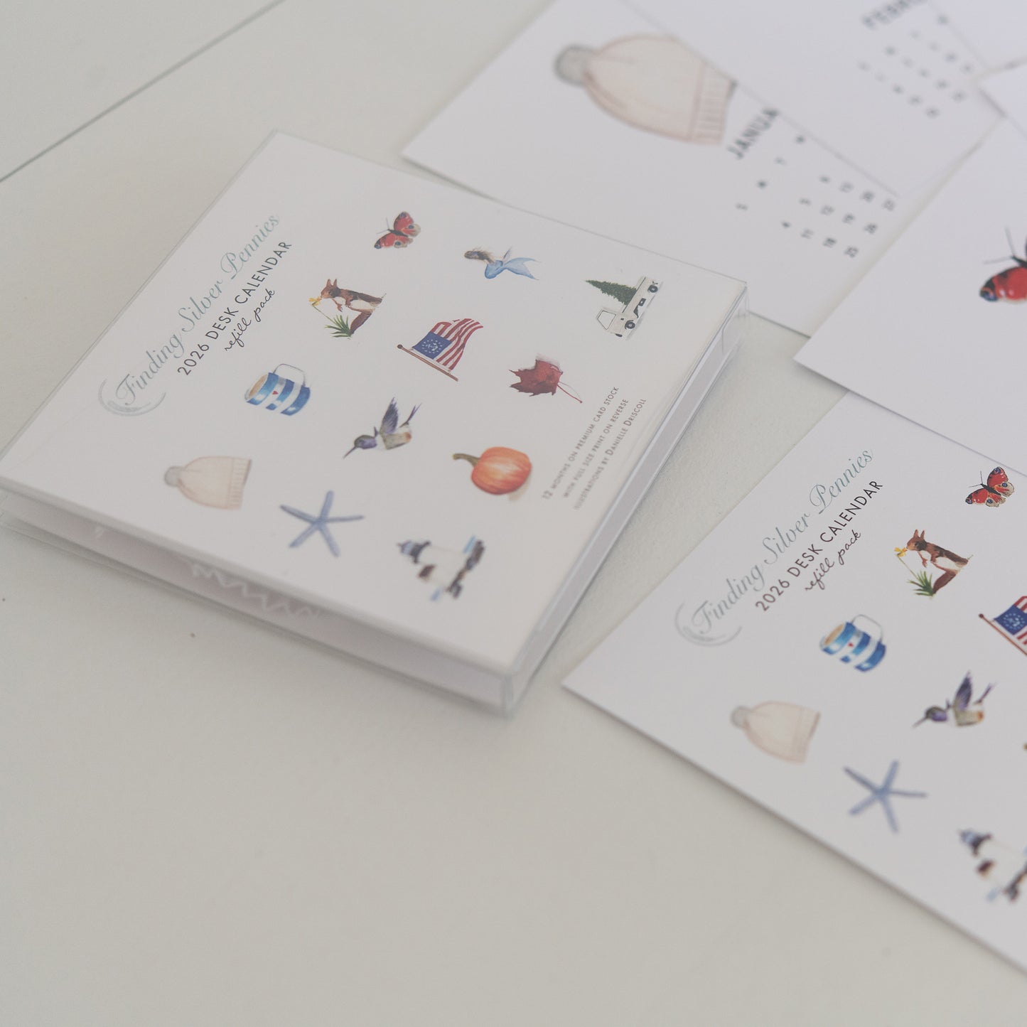 Calendar refill pack with illustrated designs on a white surface