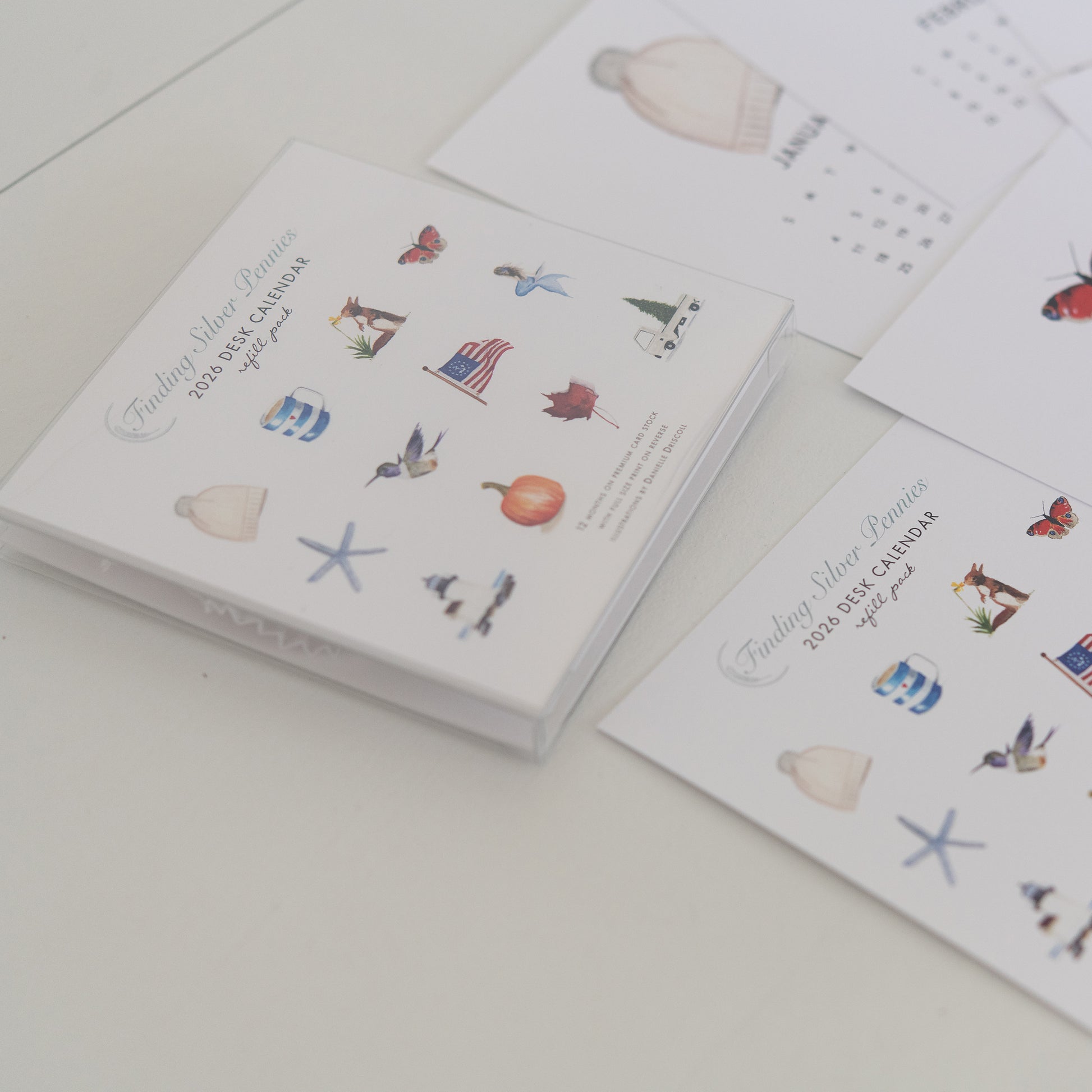 Calendar refill pack with illustrated designs on a white surface