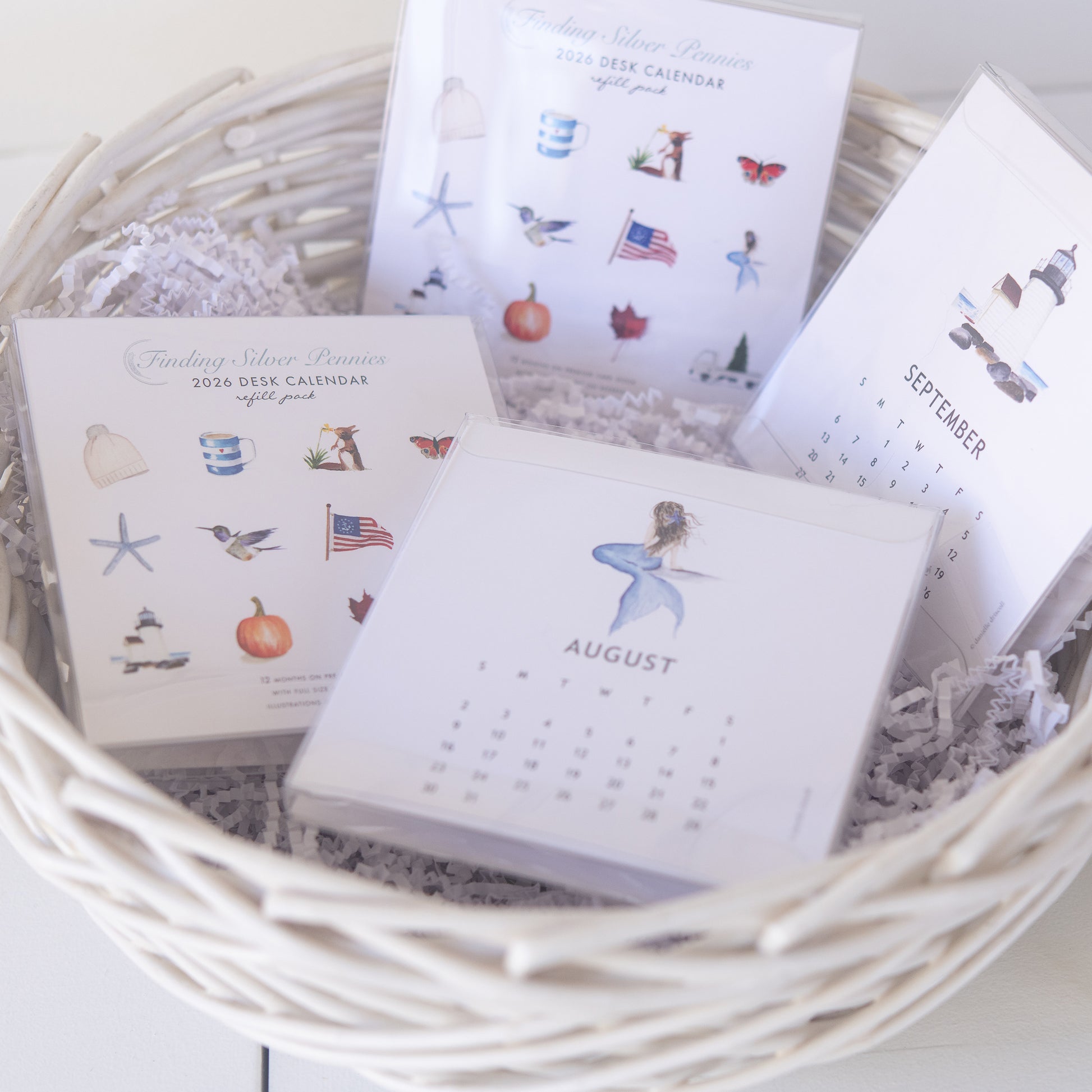 Small desk calendars refill packs with illustrations in a woven basket