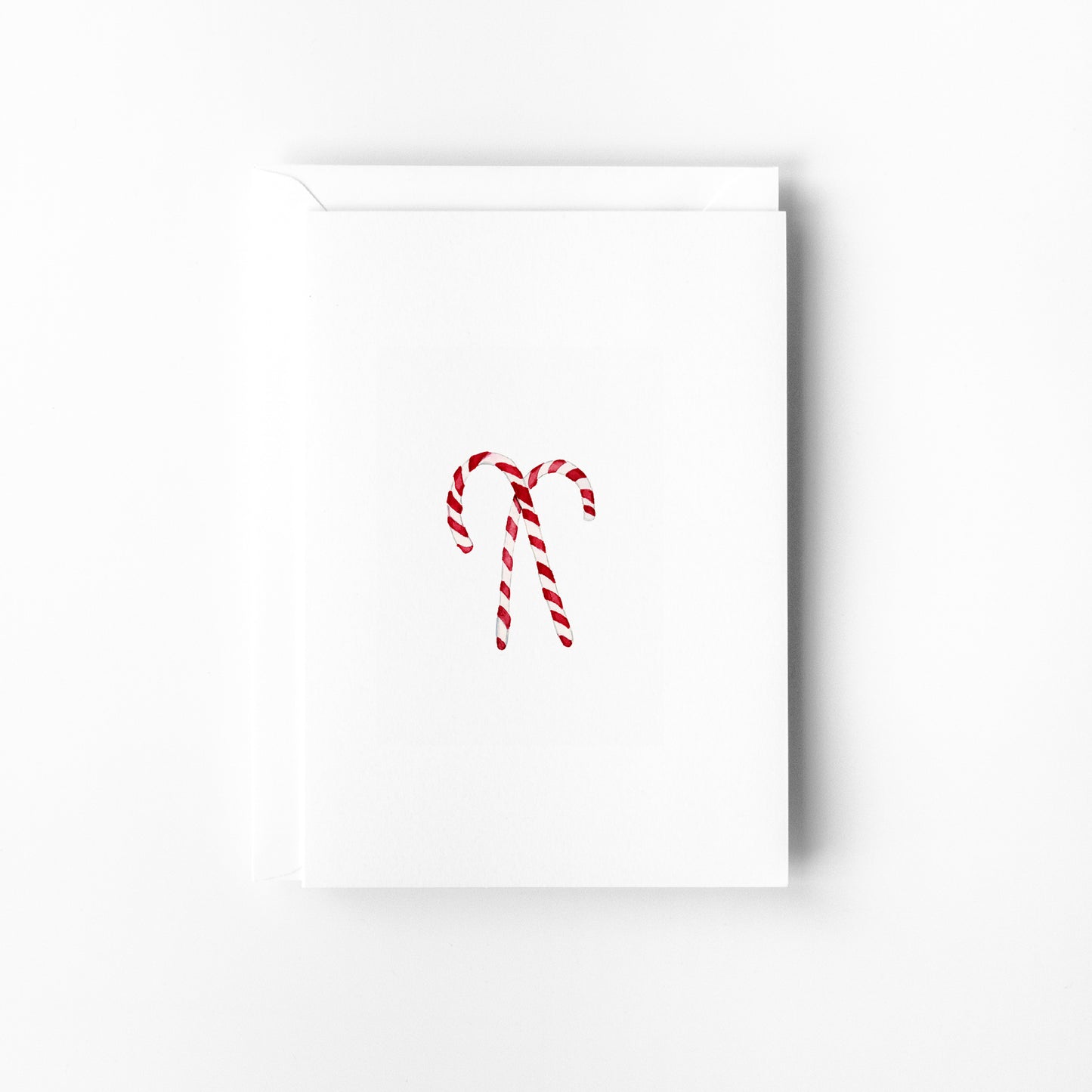 White greeting card with red candy cane design on a white background