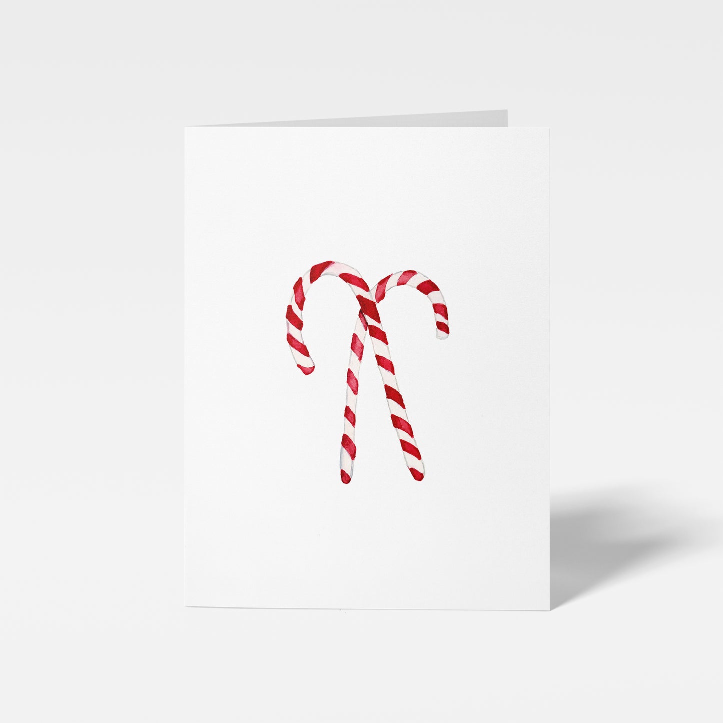 Two candy canes on a white background mini card
