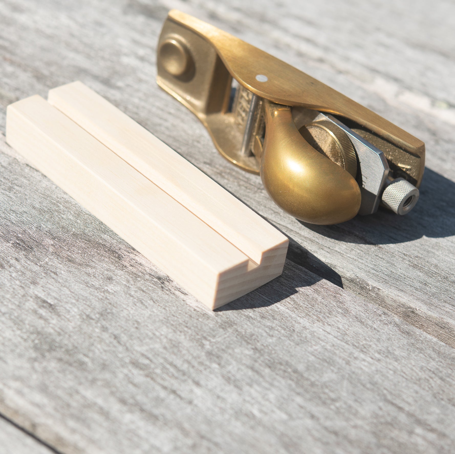 Brass plane with wooden stand