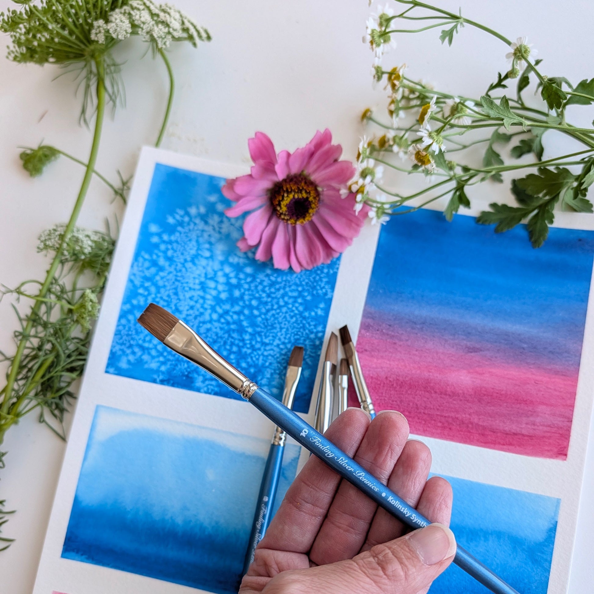 Hand holding brushes with color cards