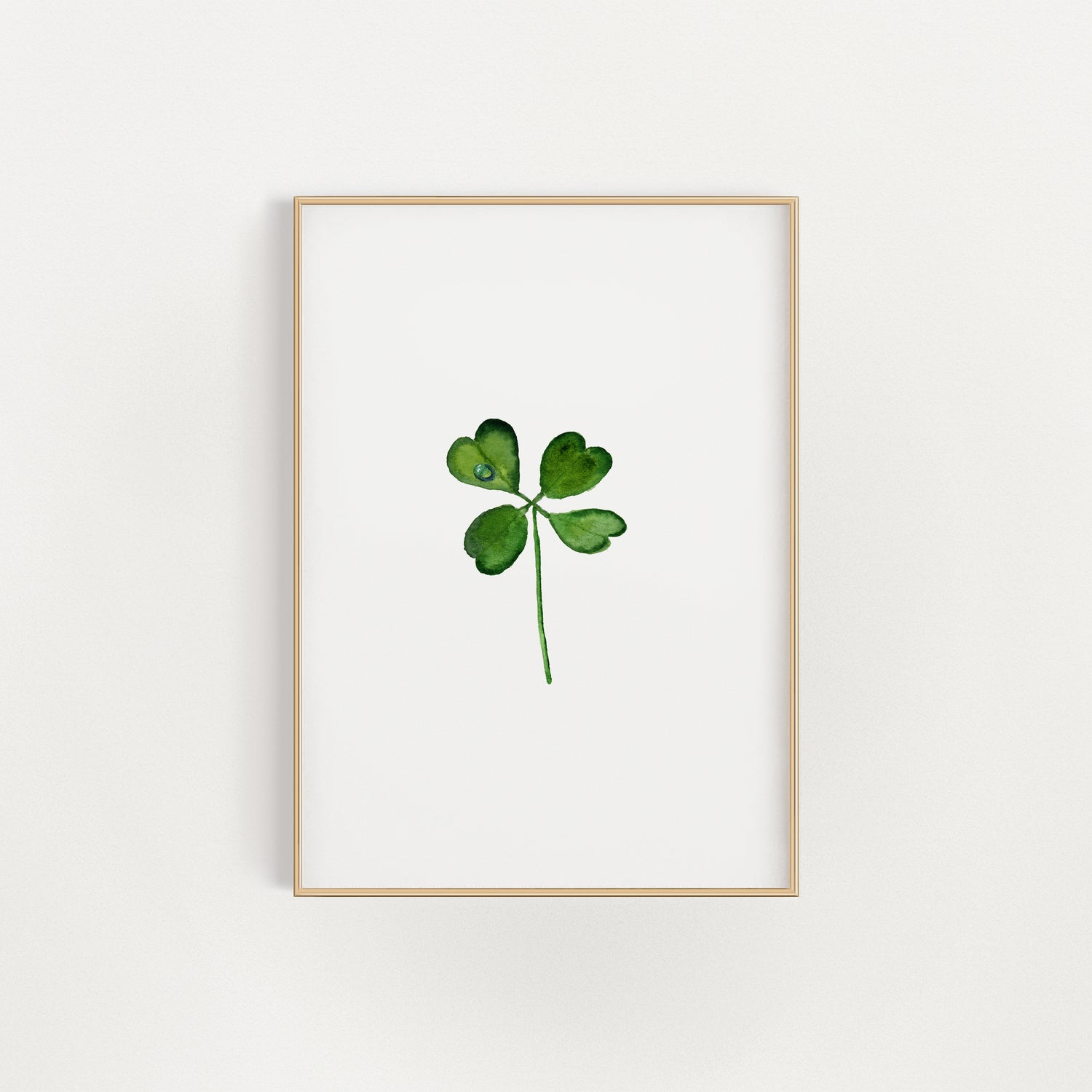 Framed artwork of a four-leaf clover print on a white background