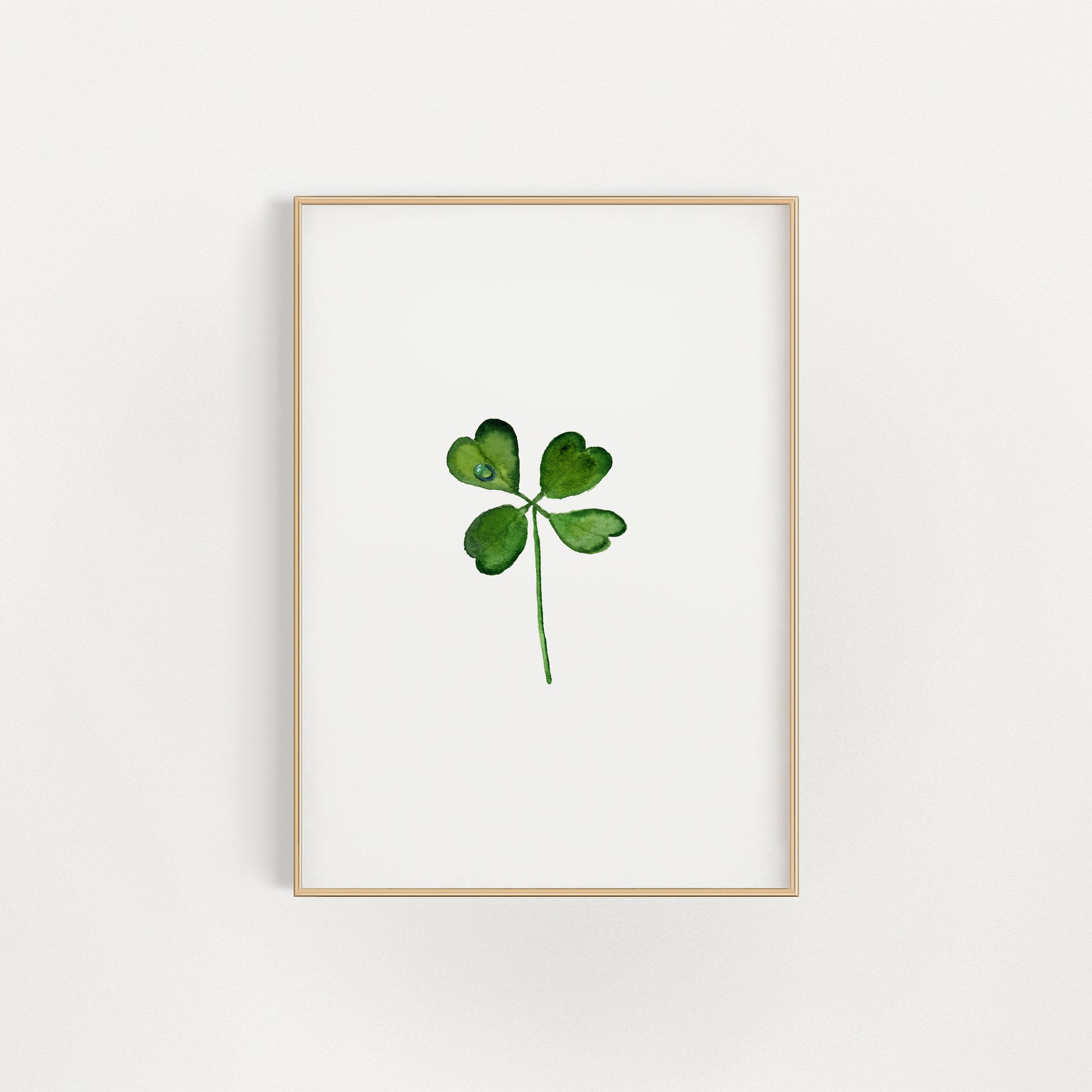 Framed artwork of a four-leaf clover print on a white background