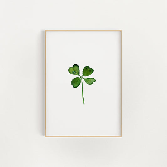 Framed artwork of a four-leaf clover print on a white background