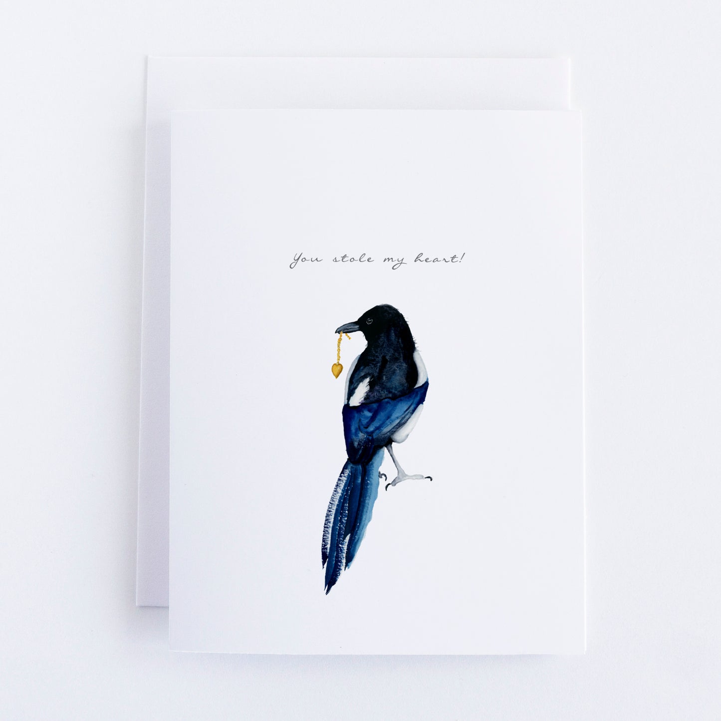 Watercolor magpie holding a gold heart with chain. Text says "You Stole My Heart!"