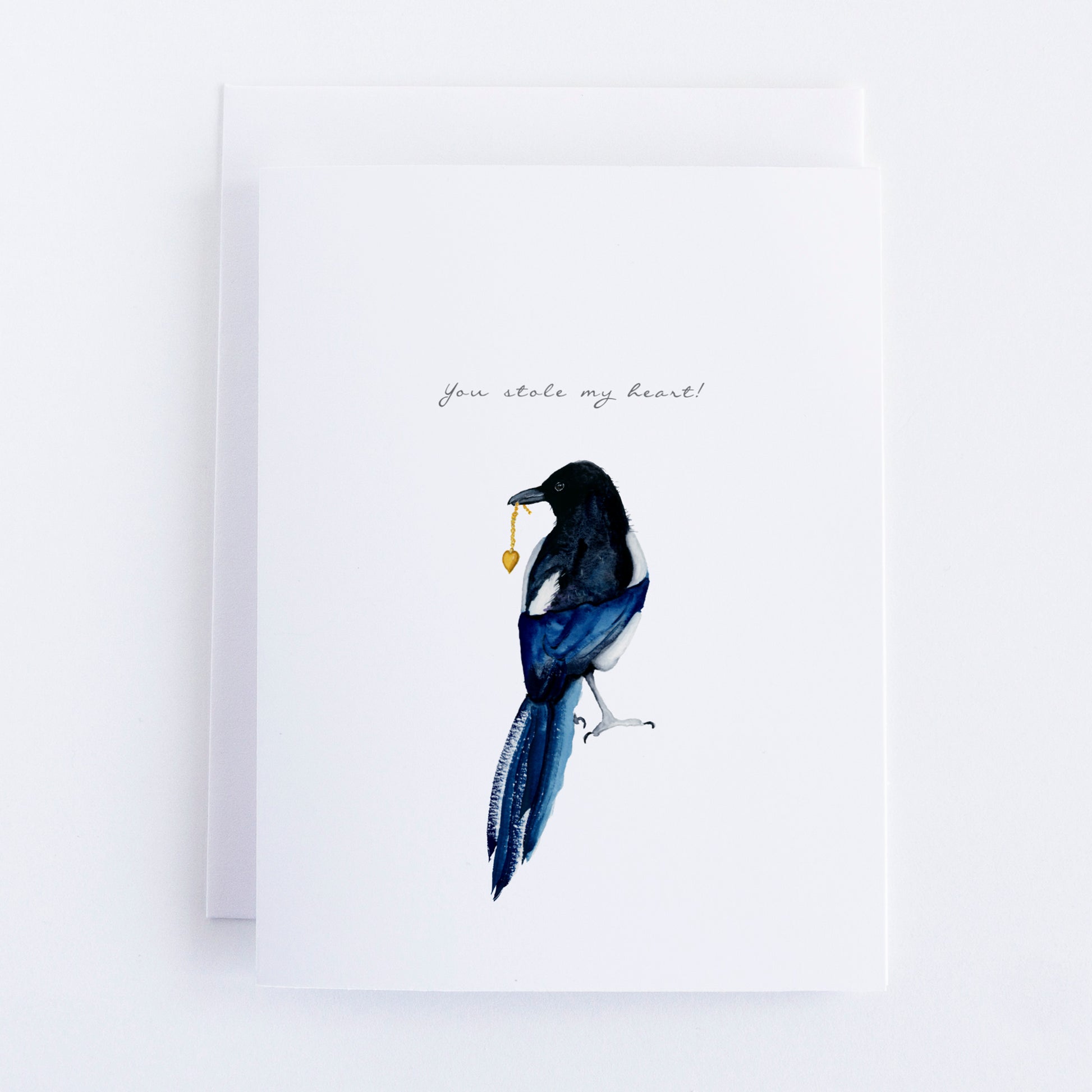 Watercolor magpie holding a gold heart with chain. Text says "You Stole My Heart!"