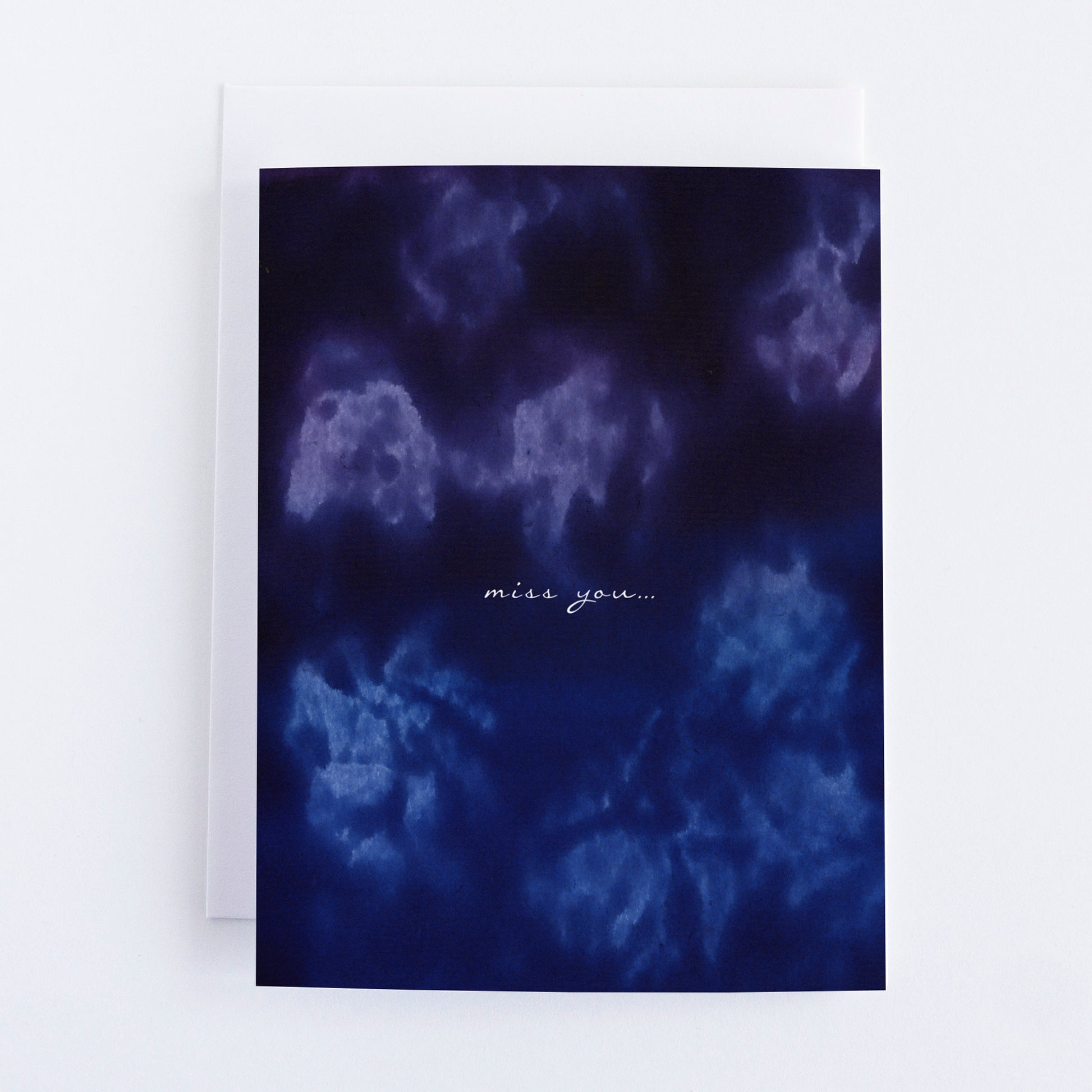 Greeting card blue and purple color wash and 'miss you' text on a white background
