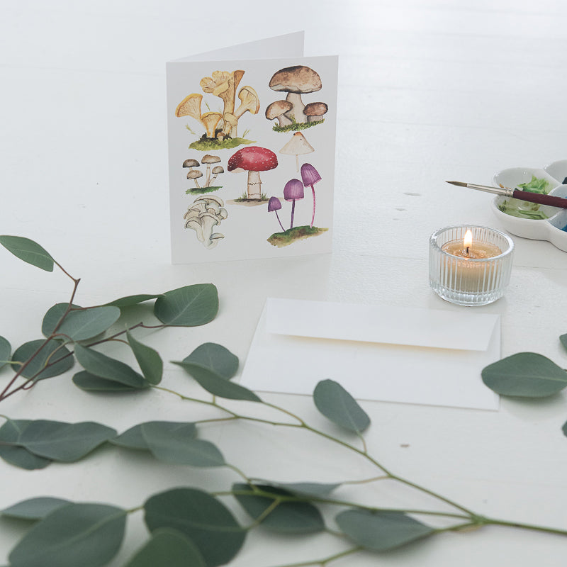 Mushroom Watercolor Note Card by Finding Silver Pennies  with greenery, candle and watercolor brush and palette#watercolor #notecard #mushrooms