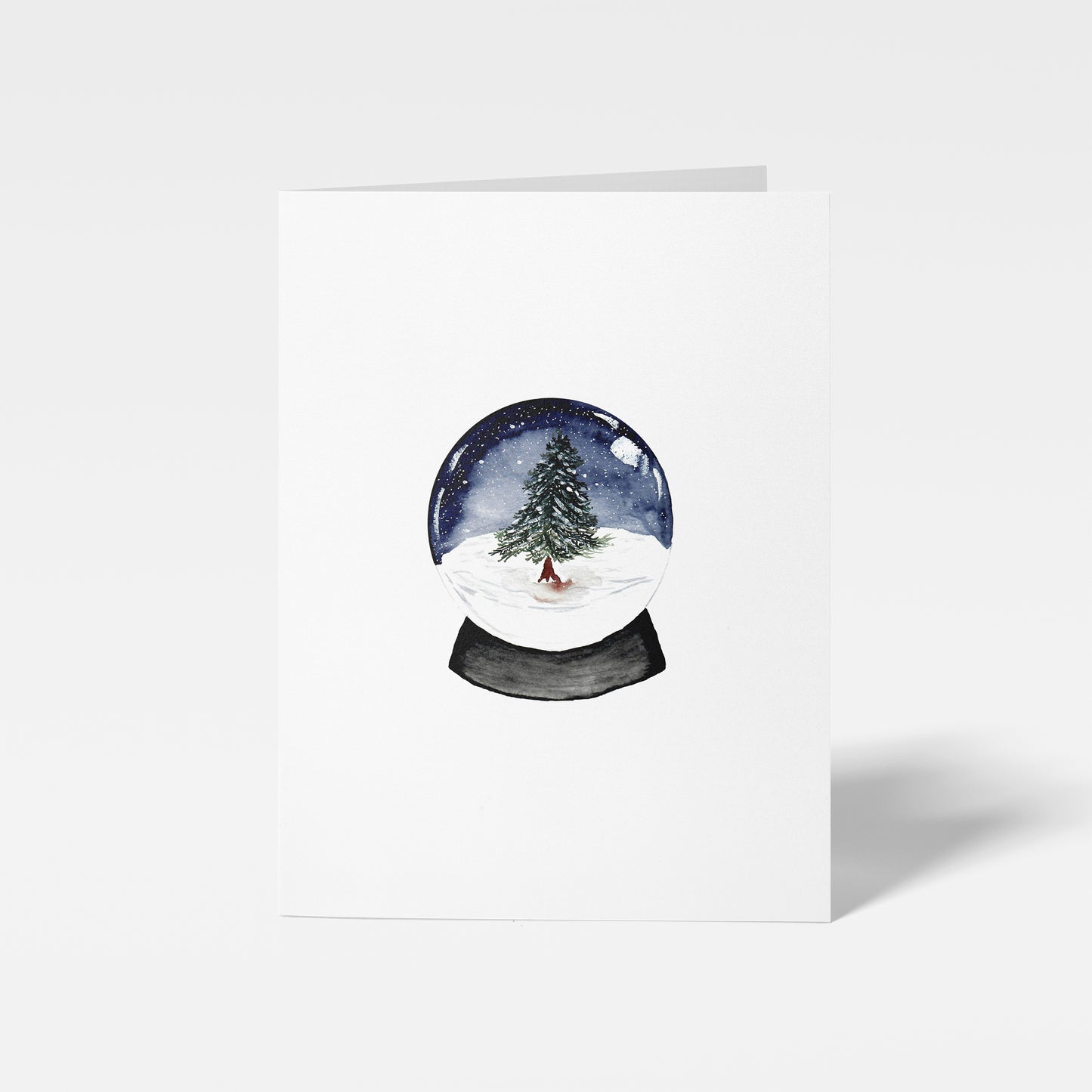 Greeting card with a snow globe design featuring a tree on a white background