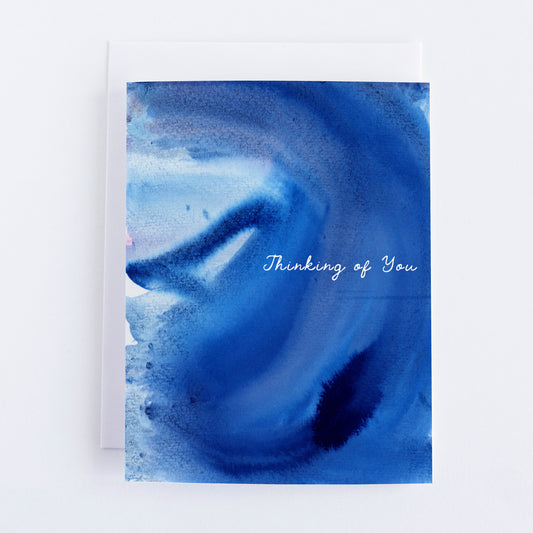 Blue watercolor card with 'Thinking of You' text on a white background