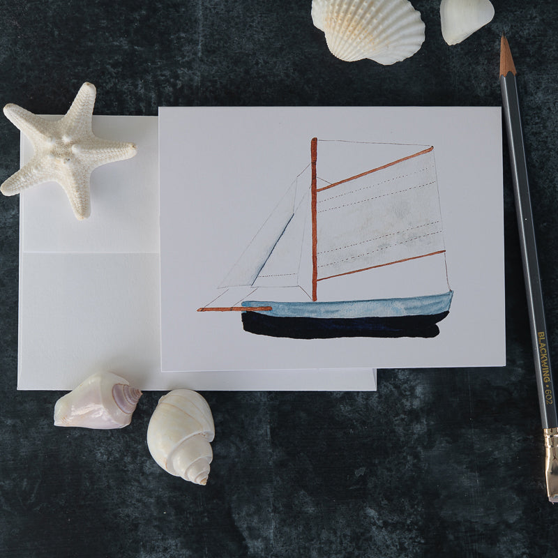 Watercolor Model Boat Note Card with pencil and shells on dark soapstone background